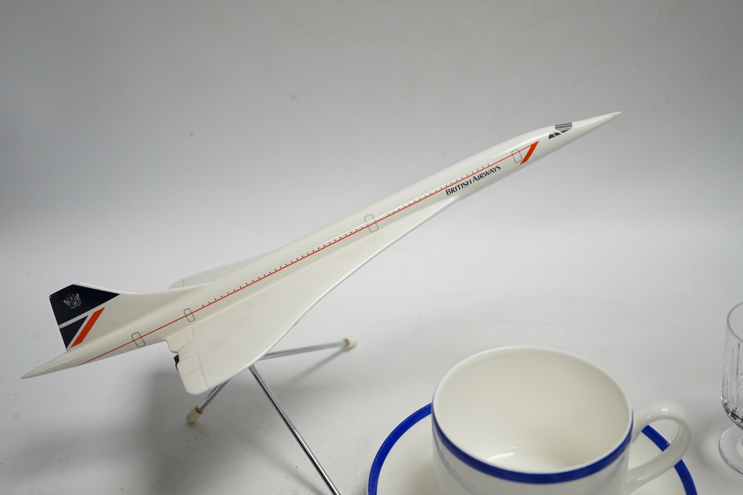 Concorde memorabilia comprising four British Airways glass tots, a pair of plated cased clothes brushes, three graduated scale models of Concorde and a bottle opener together with four Wedgwood Royal Air Force Club mugs